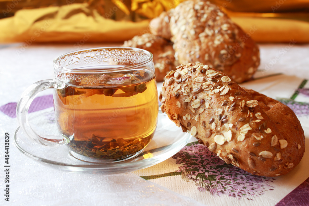 Glass cup of tea with oatmeal bun Glass cup of tea with oatmeal bun