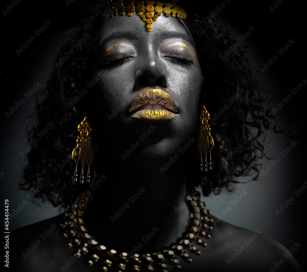 portrait of beautiful african woman with creative gold make up portrait of beautiful african woman with creative gold make up