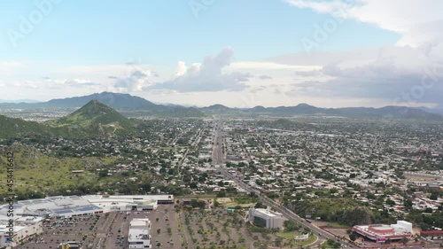 Aerial panoramic view of Hermosillo, Sonora. Drone flying sideways over Cerro de la Campana with a blue sky as background. photo