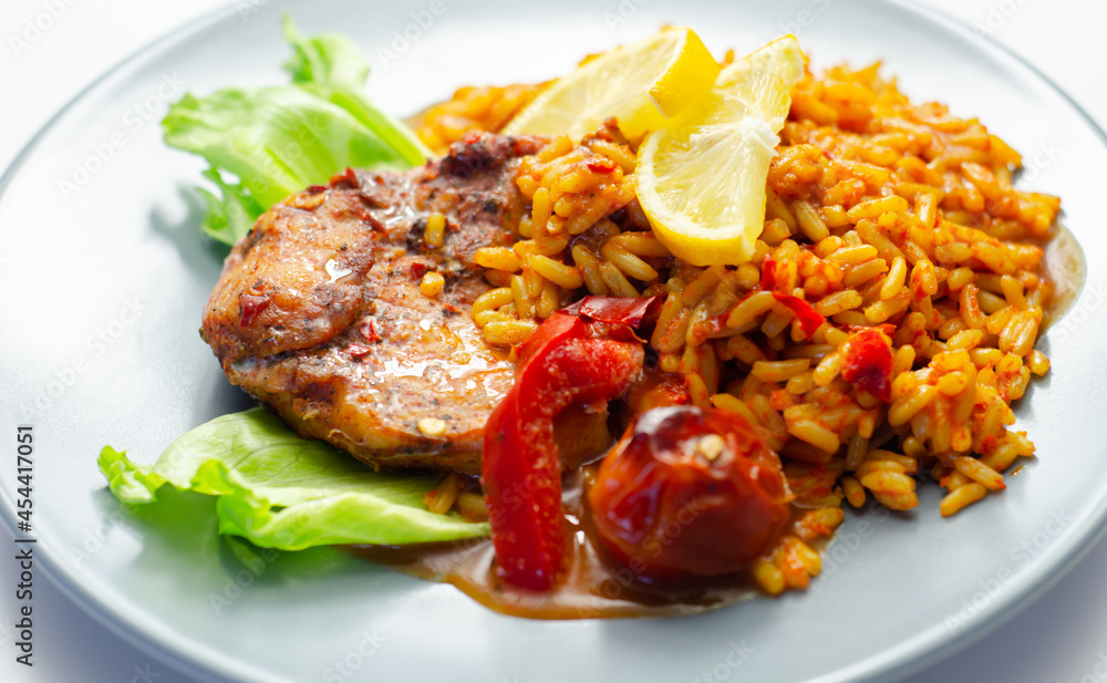 Fototapeta premium Spicy chicken breast and long grain rice with red peppers, tomatoes and jalapeno chillies