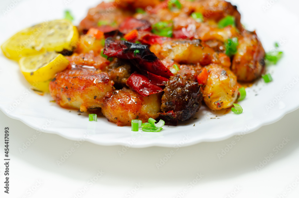 Tuscan style sauce with gnocchi, pork and beef meatballs and grilled red peppers garnished with fresh parsley and chive Tuscan style sauce with gnocchi, pork and beef meatballs and grilled red peppers garnished with fresh parsley and chive
