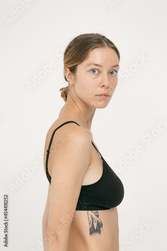 Beautiful girl without makeup with natural skin in lingerie on a white background © alexbutko_com