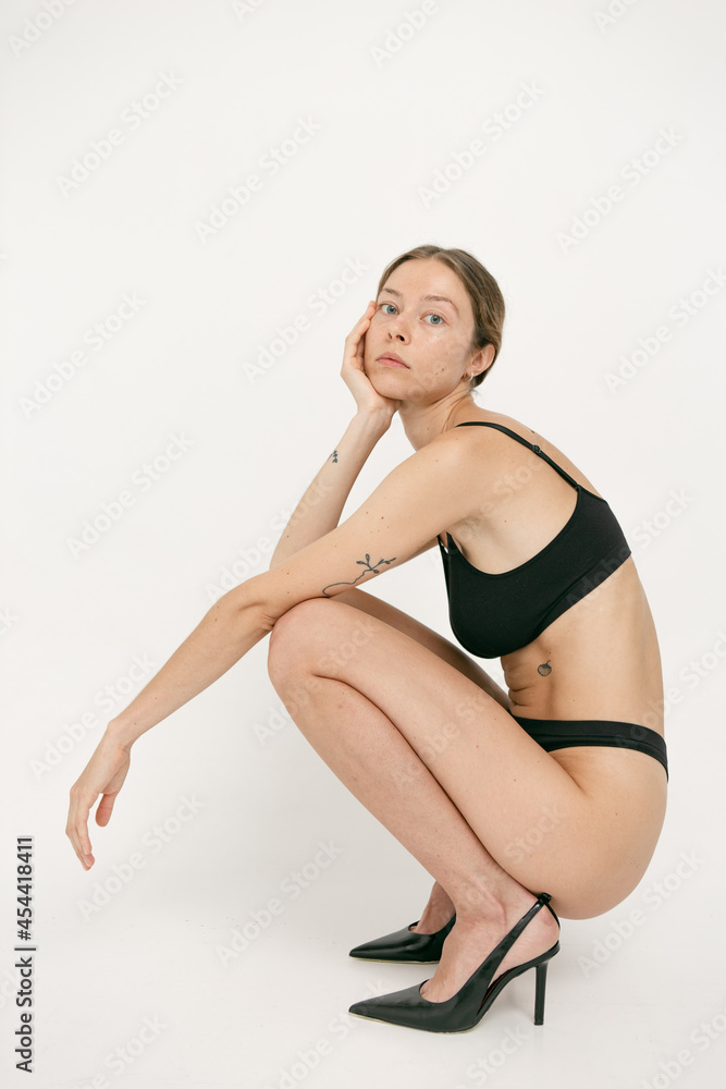 Beautiful girl without makeup with natural skin in lingerie on a white background Beautiful girl without makeup with natural skin in lingerie on a white background
