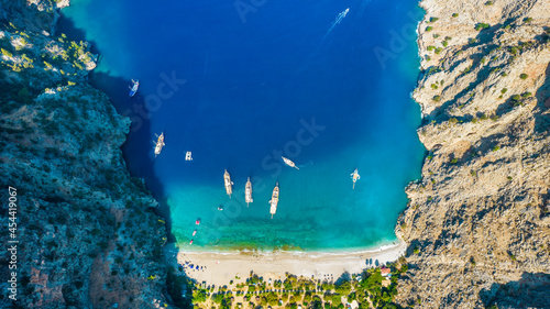 Fototapeta Naklejka Na Ścianę i Meble -  Butterfly Valley (Turkish: Kelebekler Vadisi) in Oludeniz. Beautiful beach aerial view with drone. Fethiye, Mugla, Turkey..