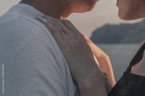 A girl's hand on a man's chest. A couple in love