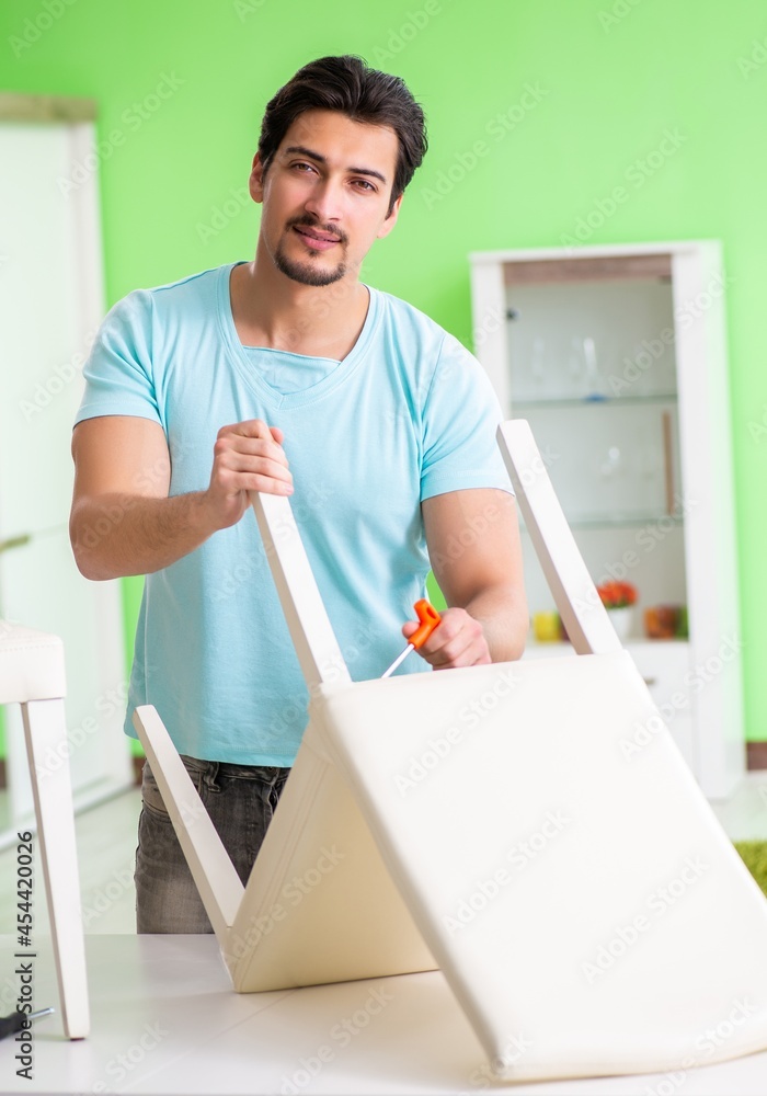 Man repairing furniture at home Man repairing furniture at home