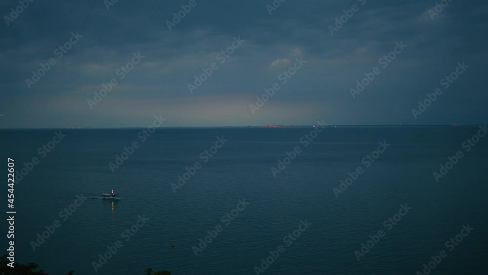 Aerial view of tourist boat on calm Adriatic Sea. Elevated view of motorboat passing by. Summer evening. Coastline in the distance. Static shot, real time Aerial view of tourist boat on calm Adriatic Sea. Elevated view of motorboat passing by. Summer evening. Coastline in the distance. Static shot, real time