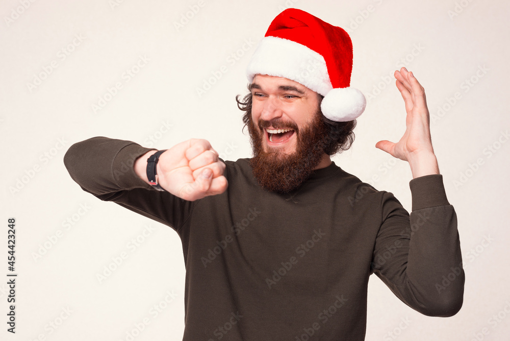 Surprised adult man is looking at his new wrist watch at Christmas time over white background. Surprised adult man is looking at his new wrist watch at Christmas time over white background.