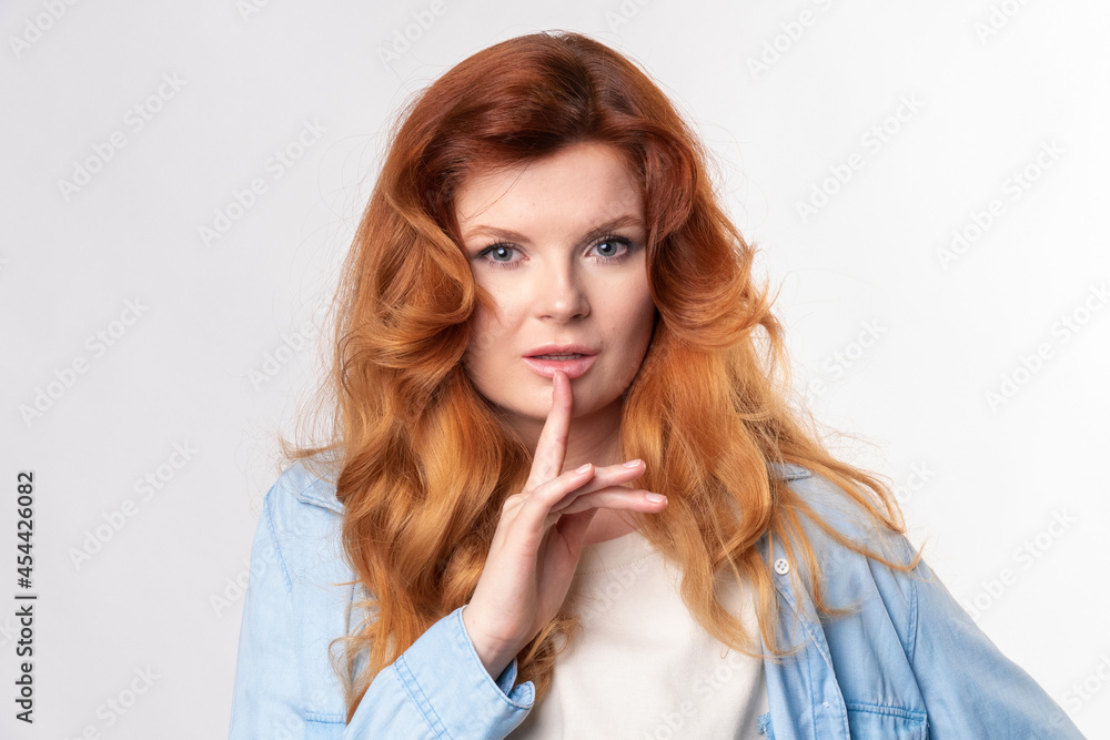 Portrait of young business woman keeping finger on her lips and asking to keep quiet, isolated over white background Portrait of young business woman keeping finger on her lips and asking to keep quiet, isolated over white background