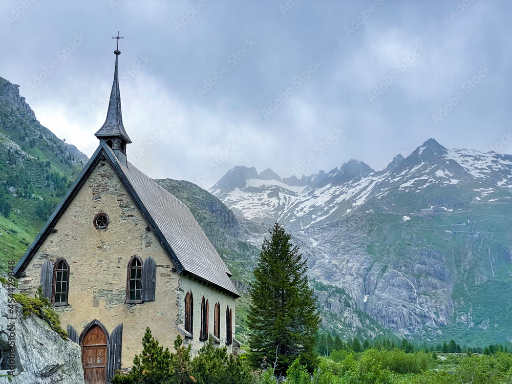 COPY SPACE: Stunning glaciers tower above a historic church in the Swiss Alps.