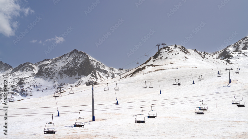 Deserted ski slopes in the middle of the coronavirus pandemic, view of the cable cars in the middle of the mountains	