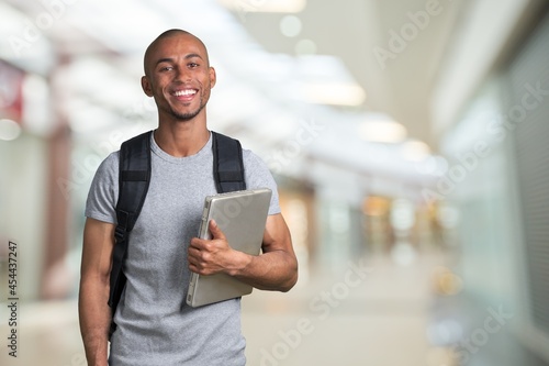 Smiling young college student with laptop © BillionPhotos.com