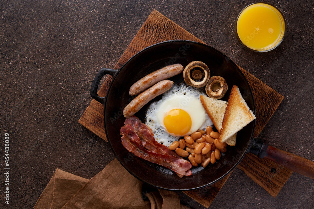 Horizontal flat lay of classic english fat morning breakfast with fried