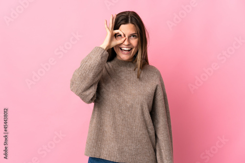 Young slovak woman isolated on pink background showing ok sign with fingers © luismolinero