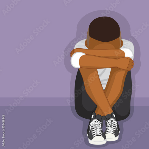 Black depressed boy sitting on floor alone bullying or depression concept 
