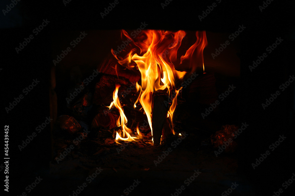 Defocus fire flame background. Firewood burning in old stove or oven. Dark and black. Orange flame. Heat energy. Out of focus Defocus fire flame background. Firewood burning in old stove or oven. Dark and black. Orange flame. Heat energy. Out of focus
