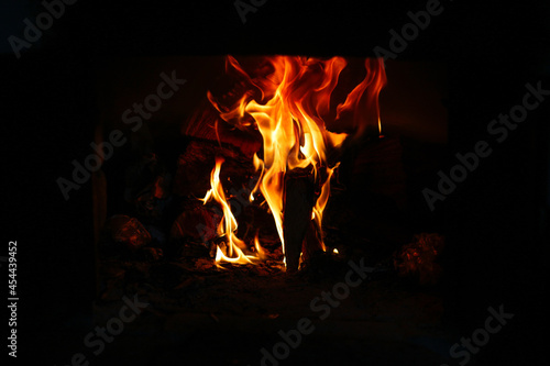 Defocus fire flame background. Firewood burning in old stove or oven. Dark and black. Orange flame. Heat energy. Out of focus