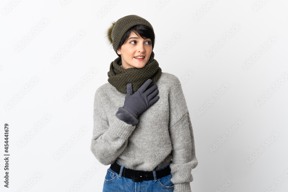 Young girl with winter hat looking up while smiling Young girl with winter hat looking up while smiling