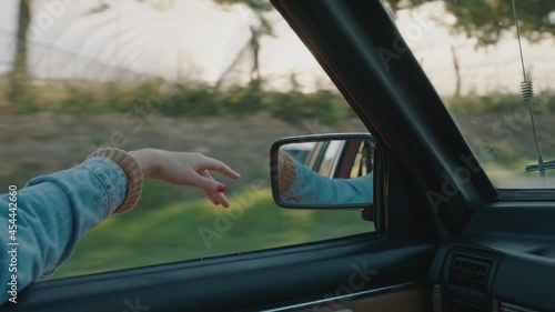 Wallpaper Mural woman holding hand out car window feeling wind blowing through fingers driving in countryside travelling on summer vacation road trip enjoying freedom on the road Torontodigital.ca