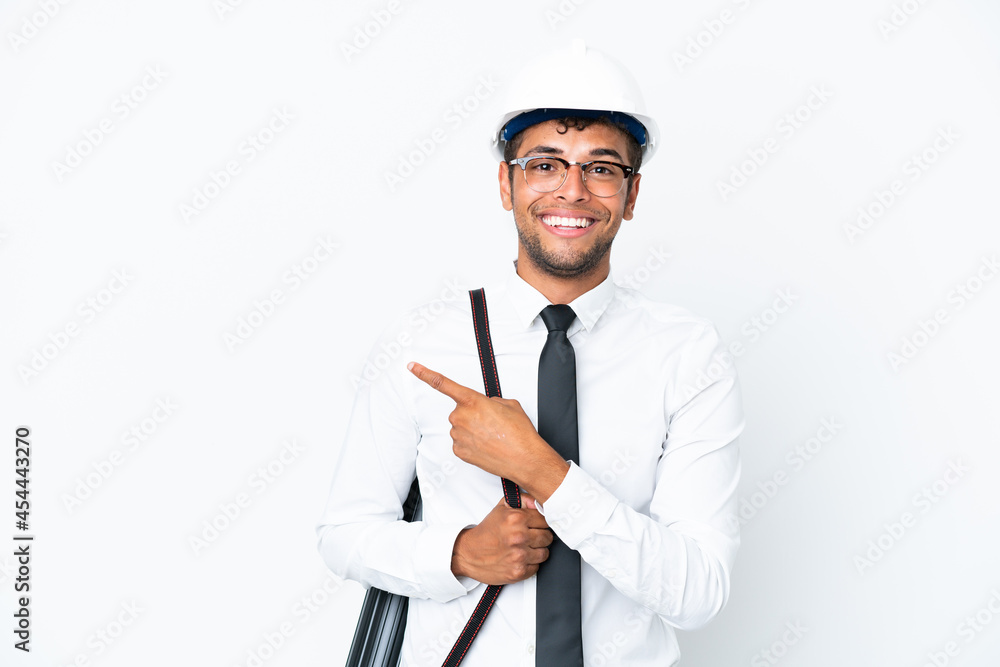 Architect brazilian man with helmet and holding blueprints pointing to the side to present a product Architect brazilian man with helmet and holding blueprints pointing to the side to present a product