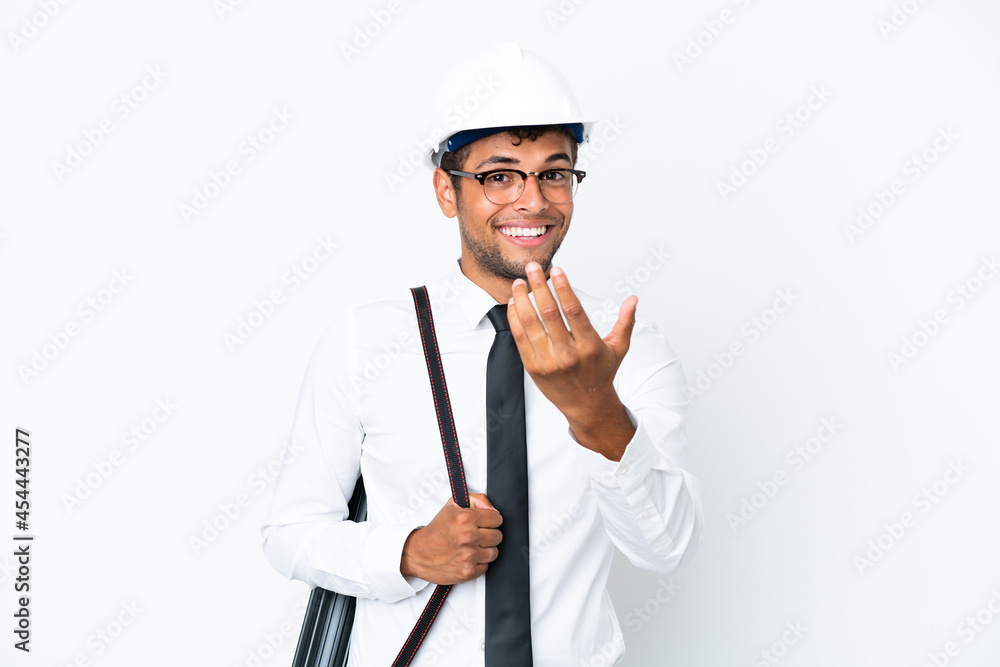 Architect brazilian man with helmet and holding blueprints inviting to come with hand. Happy that you came Architect brazilian man with helmet and holding blueprints inviting to come with hand. Happy that you came