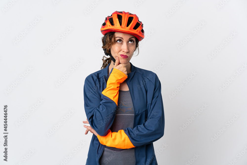 Young cyclist woman isolated on white background having doubts Young cyclist woman isolated on white background having doubts