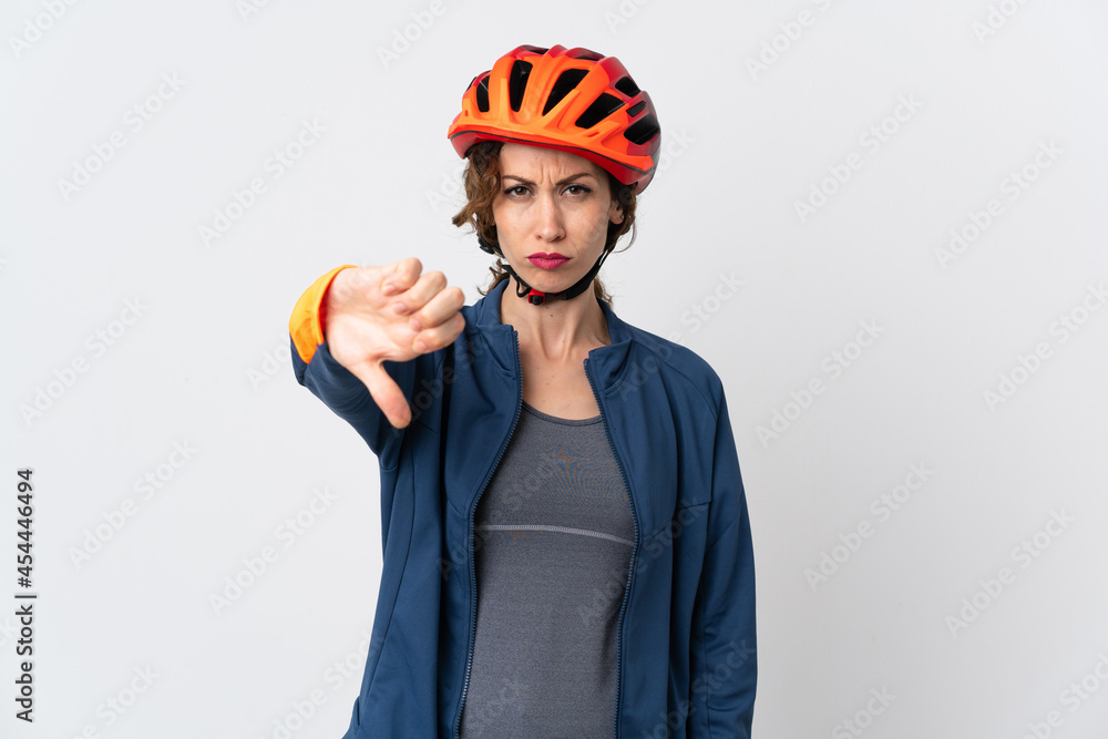 Young cyclist woman isolated on white background showing thumb down with negative expression Young cyclist woman isolated on white background showing thumb down with negative expression