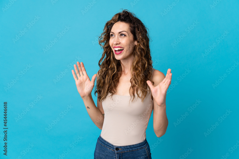Young caucasian woman isolated on blue background with surprise facial expression Young caucasian woman isolated on blue background with surprise facial expression