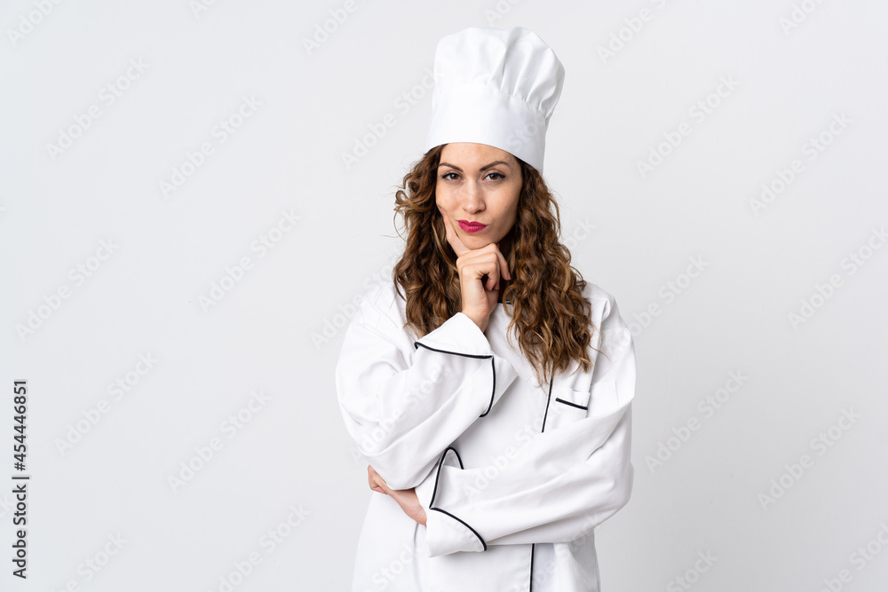 Young chef woman isolated on white background having doubts while looking up Young chef woman isolated on white background having doubts while looking up