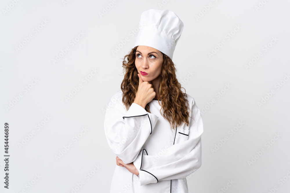 Young chef woman isolated on white background having doubts Young chef woman isolated on white background having doubts