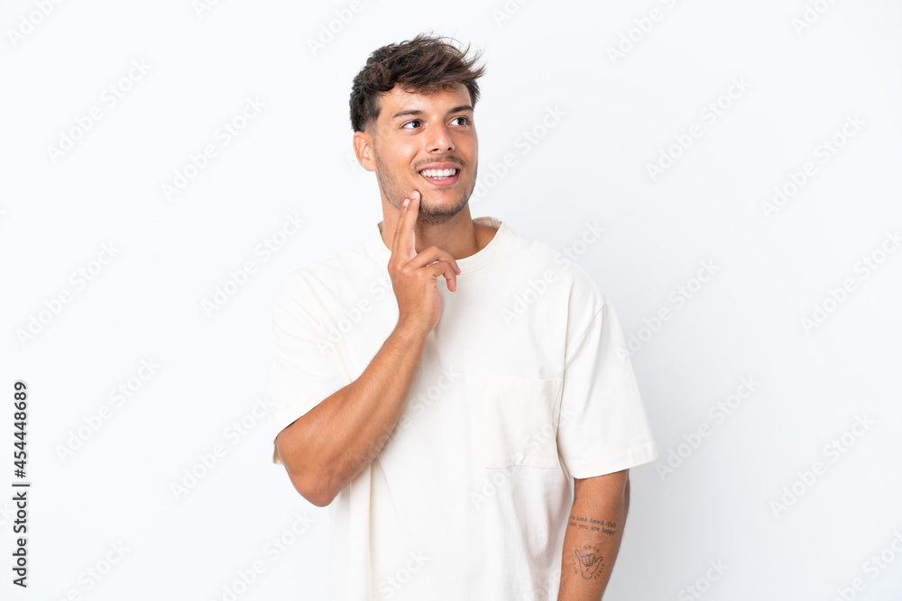 Young caucasian handsome man isolated on white background thinking an idea while looking up Young caucasian handsome man isolated on white background thinking an idea while looking up