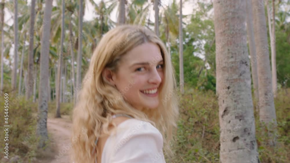 happy woman walking in palm tree forest smiling excited looking over shoulder having tropical island vacation 4k happy woman walking in palm tree forest smiling excited looking over shoulder having tropical island vacation 4k