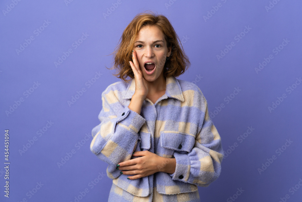 Young Georgian woman isolated on purple background with surprise and shocked facial expression Young Georgian woman isolated on purple background with surprise and shocked facial expression