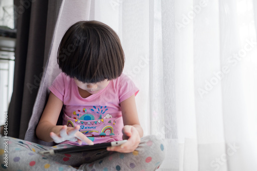 kid watching tablet, girl addicted cartoon

