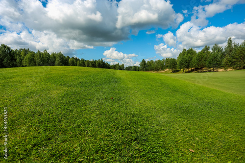 Fototapeta Naklejka Na Ścianę i Meble -  Panorama view of a Golf Course with fairway field. Golf course with a rich green turf beautiful scenery. High quality photo