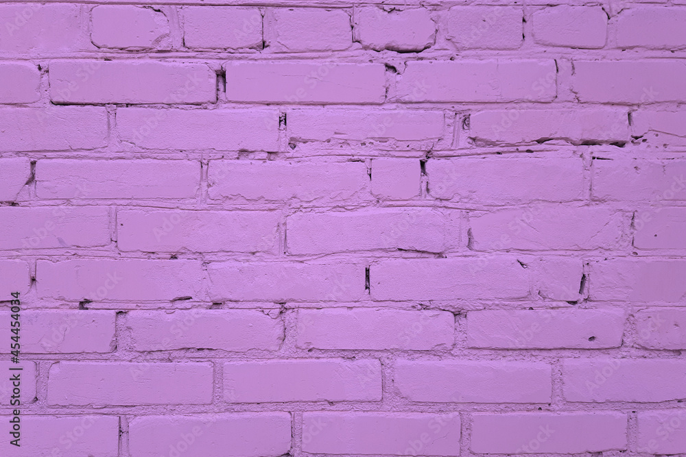 The texture of the wall made of purple bricks. Construction masonry.