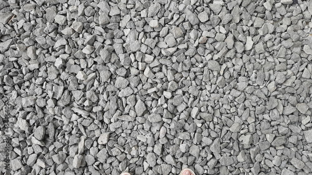 The texture of gray stones. Road surface. Minerals.