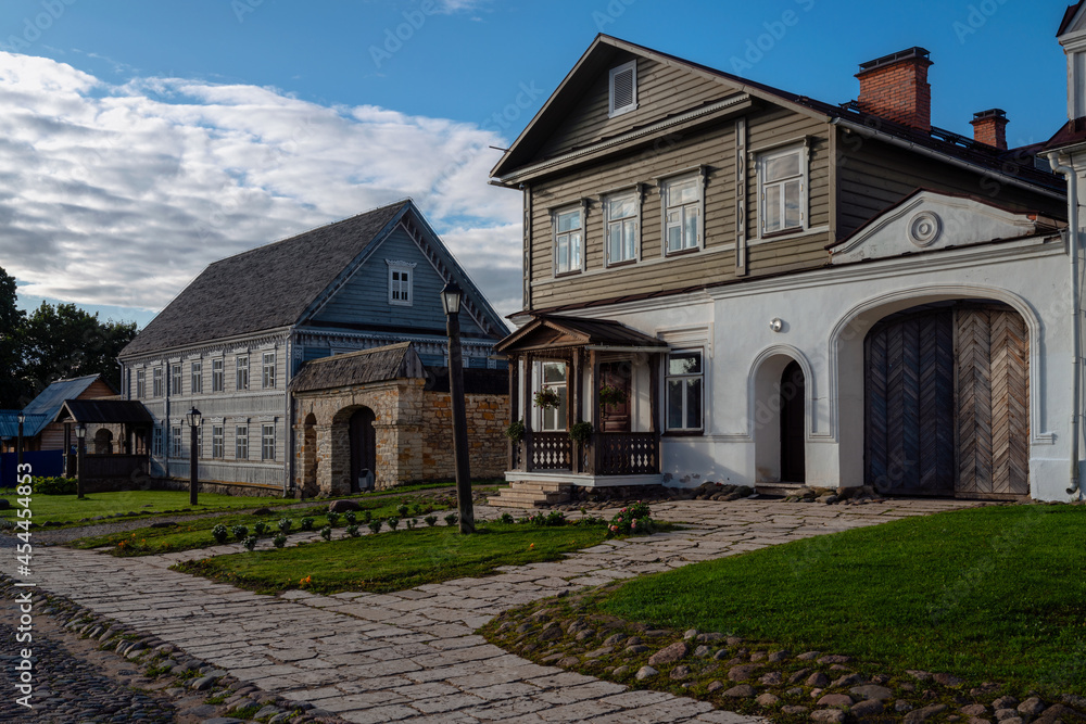 View of historical merchant buildings of estates on the main street of Izborsk Pechorskaya Street on a summer sunny day, Izborsk, Pskov region, Russia