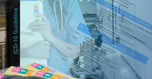 ICD-10 codebook with text of code diseases and female doctor holding medical record floder.