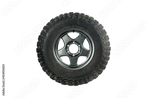 Side view of an all terrain tire with alloy wheel isolated on white background.