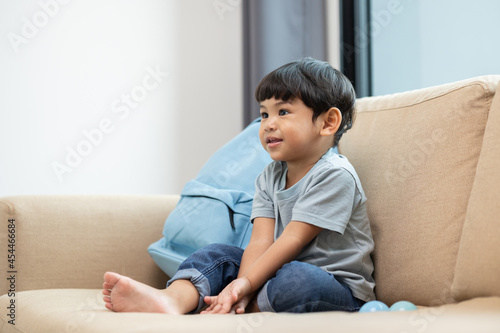 Asian little boy playing colorful ball in the living room. Sitting on sofa in the house. Developing children's learning before entering kindergarten Practice the skills.