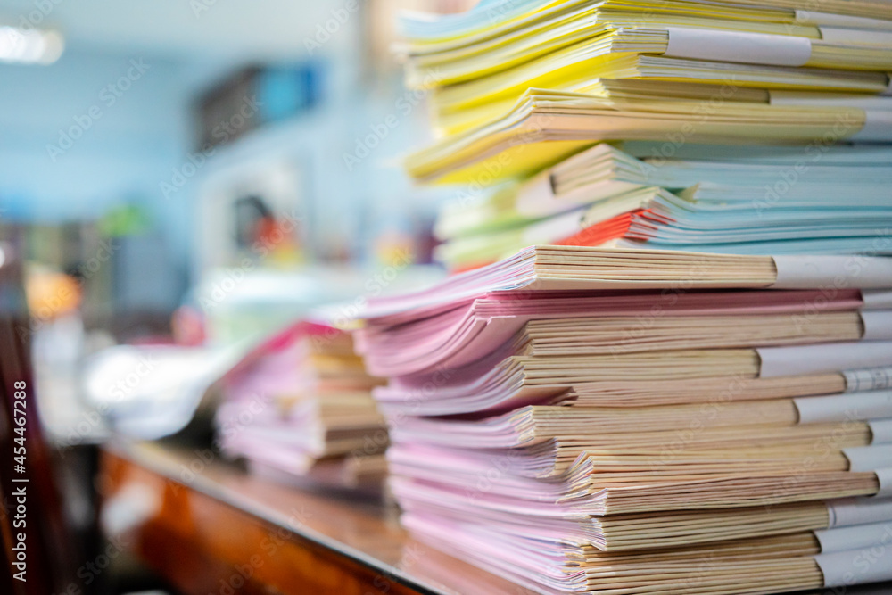 Pile of unfinished documents on office desk Pile of unfinished documents on office desk