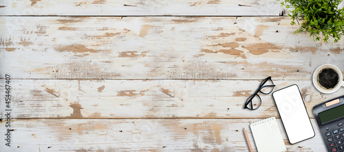 smart phone, calculator and notebook on wooden table