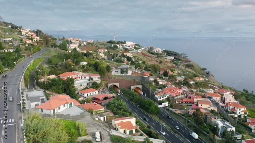 Madeira Islands, Portugal. Aerial view of tunnels and winding roads with a seascape in the background. Coastal town with traditional architecture as seen from above. High quality 4k footage Madeira Islands, Portugal. Aerial view of tunnels and winding roads with a seascape in the background. Coastal town with traditional architecture as seen from above. High quality 4k footage