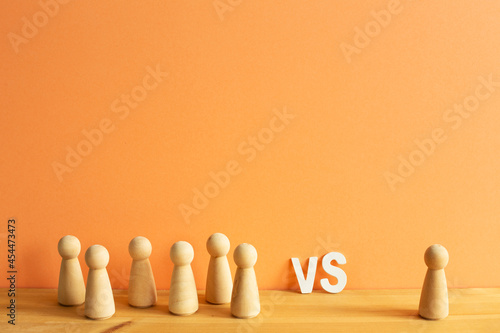 Obraz na płótnie Majority vs minority concept. Wooden human figure on desk. orange background w salonie