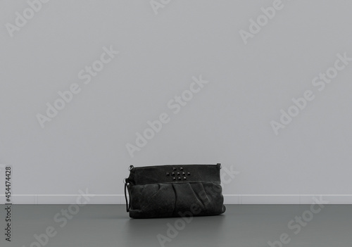 A women's handbag on the floor , cloth and accessories in a grey interior room with copy space, 3d Rendering