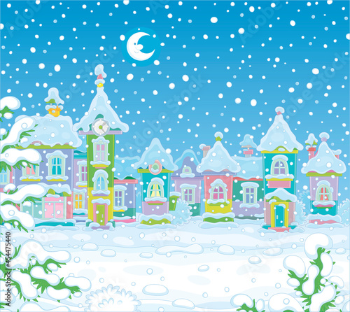 Christmas background with colorful toy houses of a pretty small town on a snowy winter night, vector cartoon illustration