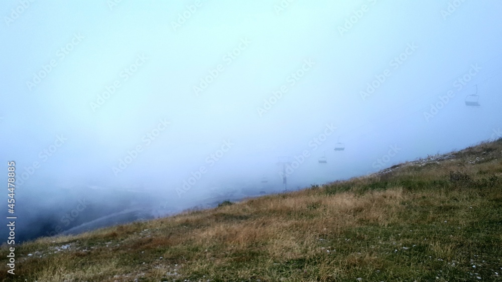 Misty morning on the mountain Bjelasnica, view from peak, cable cars in the fog, Bosnia and Herzegovina