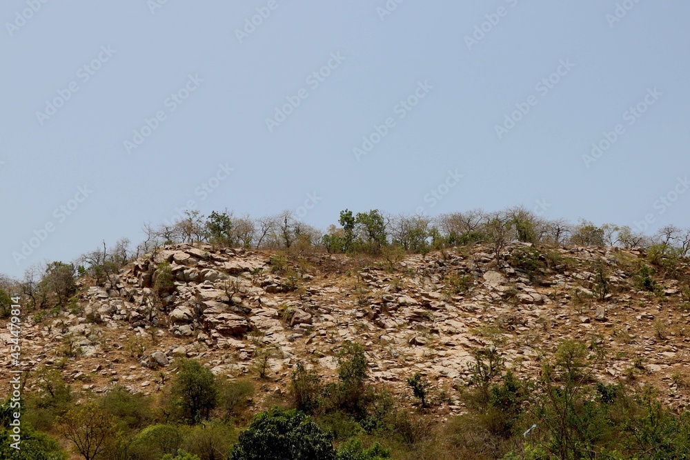 Image of small hill with big big rock
