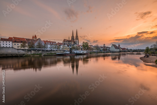 Regensburg during sunset with Danube river and cathedral and stone bridge at golden hour  Germany